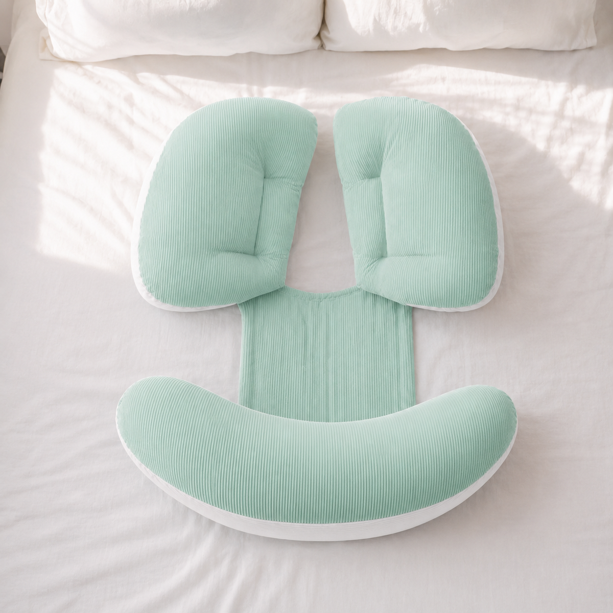 NuriBloom Devora ergonomic baby carrier worn by mother with newborn indoors